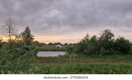white clouds in the sky before rain over the river