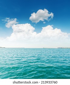 white clouds and turquoise sea