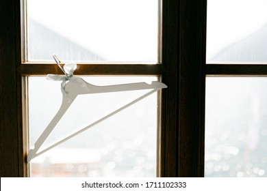 A White Coat Hanger Hangs On The Window