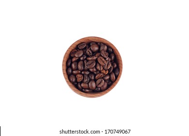 White coffee beans in a wooden bowl on the white background