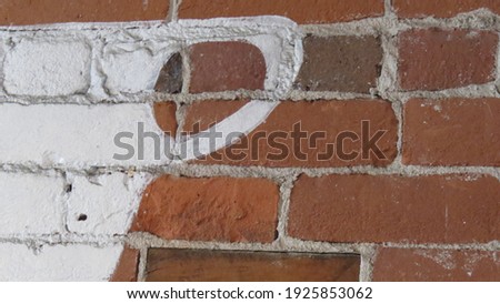White Coffee Cup Handle painted on Brick Wall