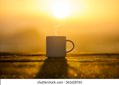 White Coffee Cup In The Morning Time With Sunrise.