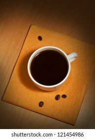 A White Coffee Cup On A Yellow Napkin, Top View