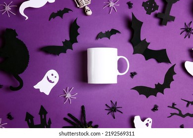 White coffee mug mockup for design, quote, brand or logo with Halloween decorations. White ceramic mug on purple background. - Shutterstock ID 2192569311