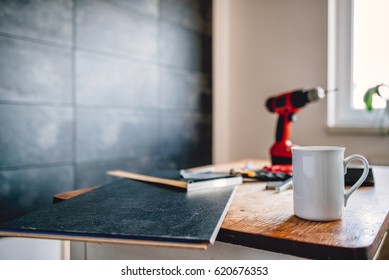 White Coffee Mug On Table With Tools