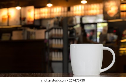 White Coffee Mug On Wooden Table In Cafe With Copyspace