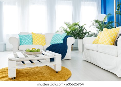 White coffee table made of wooden pallet in cozy living room - Powered by Shutterstock