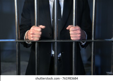 A white collar criminal behind bars after being arrested for banking crimes