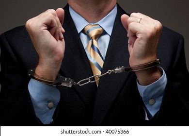 White Collar Criminal In A Business Suit And Handcuffs