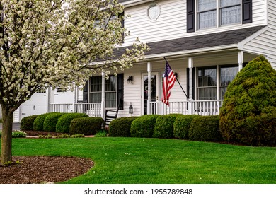 White Colonial House With American Flag