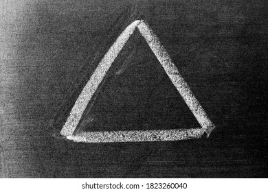 White Color Chalk Hand Drawing In Triangle Shape On Black Board Background