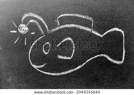 White color chalk hand drawing in angler fish or lantern fish shape on black board background