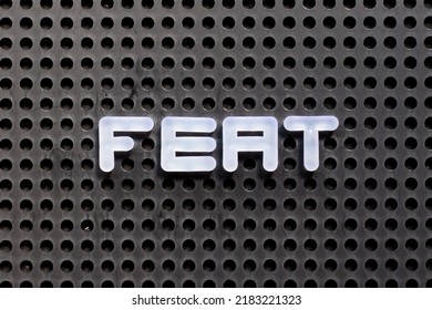 White Color Letter In Word Feat On Black Pegboard Background