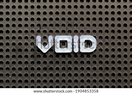 White color letter in word void on black pegboard background