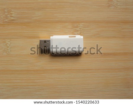 White color USB flash pen drive kept on wooden table
