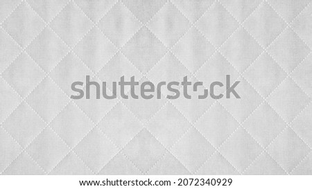 White colored seamless natural cotton linen textile fabric texture pattern, with diamond quilted, rhombic stiching.  stitched background