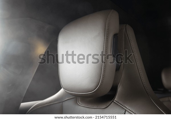 White comfort leather passenger seat headrest in\
modern sports car