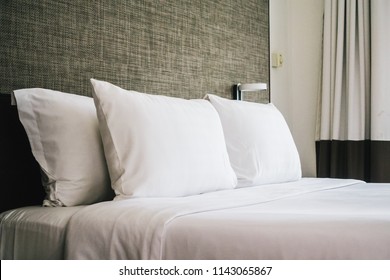 White Comfortable Pillow On Bed Decoration Interior Of Hotel Bedroom