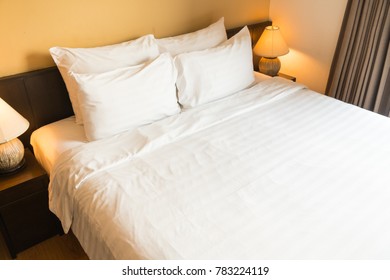 White comfortable pillow on bed with light lamp decoration interior of bedroom - Shutterstock ID 783224119