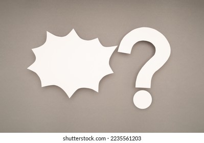 White comic speech bubble and a white question mark on a gray background. Space for text. Top view - Powered by Shutterstock - Get 15% off with code: PIKWIZARD15