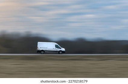 White Commercial Van on Countryside Road delivering goods. Motion Blurred Background - Powered by Shutterstock