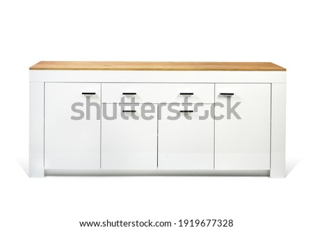 White commode on light wall background.