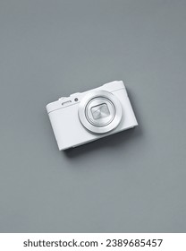 white compact digital camera on grey background