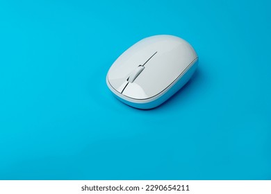 White Computer Mouse Mockup, Click Concept, Wireless Technology, PC Computer Mouse on Blue Background Top View, Copy Space