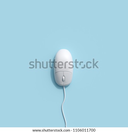 A White computer mouse on blue background. top view, flat lay minimal concept.