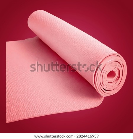 White computer mouse with red cord on red surface background