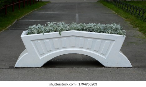 White Concrete Flowerbed Blocking The Entrance