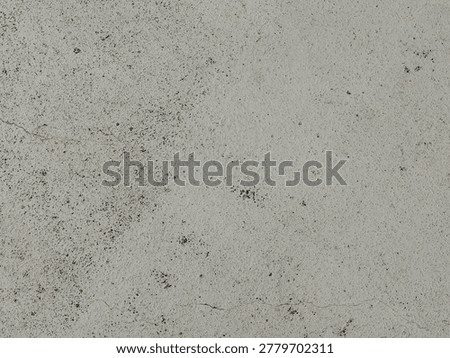 White concrete wall texture with subtle dirt marks and rough surface for minimalist abstract background design. 