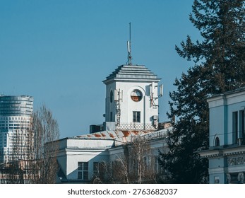White constructivist tower with round windows against a clear blue sky