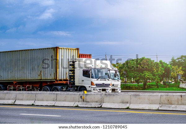 White container truck on highway road ,\
transportation concept ,import,export logistic industrial\
Transporting Land transport on the\
expressway