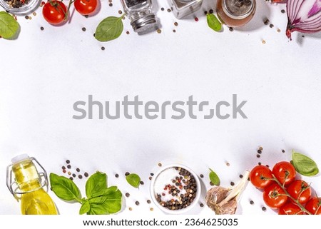 White cooking background with useful cooking italian Mediterranean ingredients - tomatoes, basil leaves, greens, olive oil, salt, pepper, garlic, flat lay white table top view copy space 