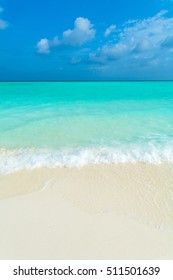 White coral sand beach of tropical Island with rolling ocean waves, Maldives - Shutterstock ID 511501639