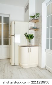 White corner bedside table and cream-colored white refrigerator in the kitchen