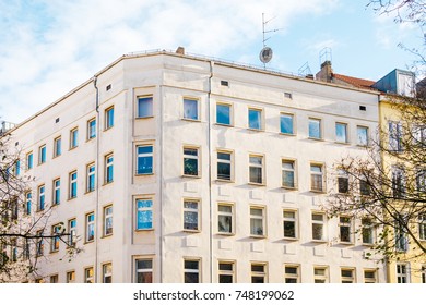 white corner building with fluffy clouds
