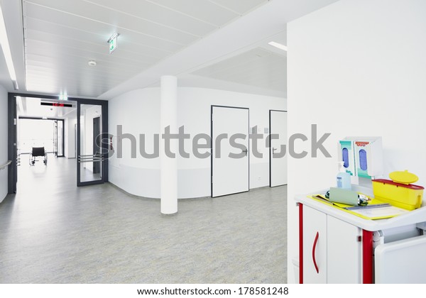 White corridor in\
hospital with trolley