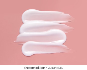 White Cosmetic Cream Lotion Swatch Smear Smudge On Pink Color Background. 