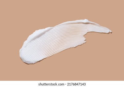 White cosmetic cream lotion swatch smear smudge on brown color background.  - Shutterstock ID 2176847143