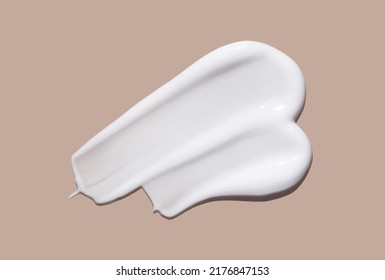 White cosmetic cream lotion swatch smear smudge on brown color background.  - Shutterstock ID 2176847153