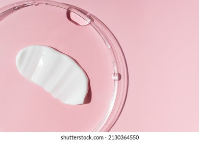 White Cosmetic Face Cream Texture In Petri Dish. Lotion Smear On Pink Background. Beauty Skincare Product Swatch. Cream Smudge.