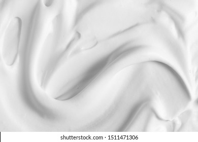 White cosmetic foam texture background. Cosmetic mousse, cleanser, shaving foam, shampoo. Foamy skin care product