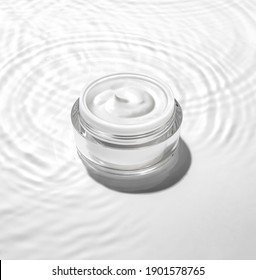 White Cosmetic Jar On The Water Surface. Summer Water Pool Fresh Concept.
