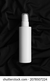 White Cosmetic Lotion Bottle Mockup On The Black Textile.