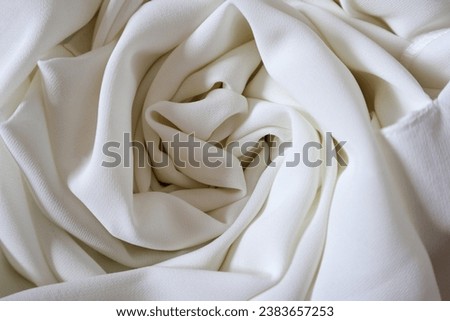 White cotton cloth in spiral shape, white textile background photo