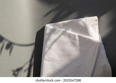 White Cotton Fabric Piece On Grey Background With Flowers Shadows. Mockup. Lifestyle Scene