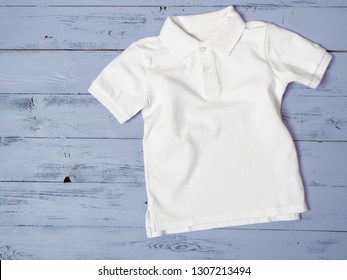 White Cotton Pique Polo Classic Look For Kids Child Baby. Fashion, Shopping Concept. Template For Online Store, Flat Lay, Top View From Above