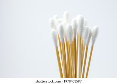White cotton swab or cotton buds isolated on white background. Heap of bamboo cotton swab or wooden ear stick handle Eco-friendly materials, Closeup. Zero waste concept, top view